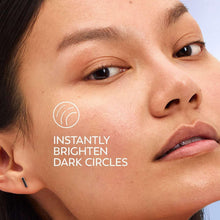 Woman close-up applying eye serum with “instantly brighten dark circles” text