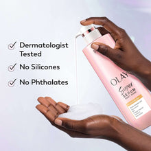 Pink body wash bottle held by hands, with white lather on palms