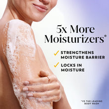 Foamy body wash on arm and hands with '5x More Moisturizers' text overlay
