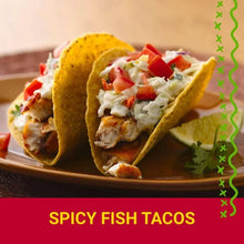 Two crunchy tacos topped with diced tomatoes, shredded lettuce, and sauce