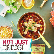 Old El Paso taco seasoning mix with bowl of chili and lime garnish