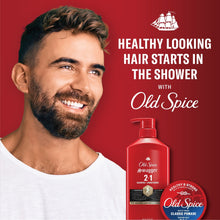 Red 2-in-1 shampoo and conditioner bottle with pump near smiling man