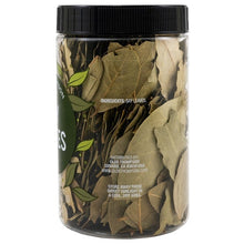 Dried bay leaves in a clear jar, with ingredients and storage information on the label.