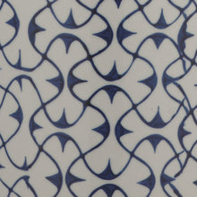 Ceramic lamp base pattern with navy blue scroll motifs on white background