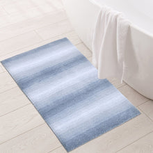 Blue ombre bath mat with soft plush texture, rectangular