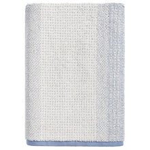 Light blue and cream ombre bath towel, folded with textured terry surface