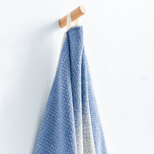 Blue ombre bath towel hanging, cream accent panels visible