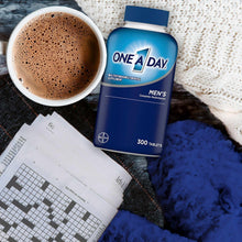 Men's multivitamin bottle with blue cap beside a cup of coffee and paper