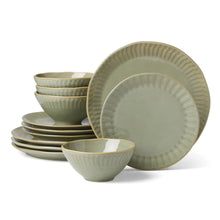 Green stoneware tableware set with dinner plates and bowls, ribbed rims