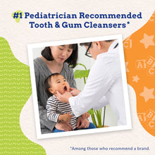 Baby oral care with green finger toothbrush held by caregiver