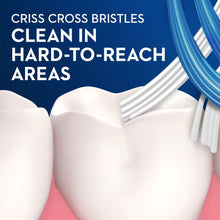 Manual toothbrush head with crisscross bristles for hard-to-reach areas.