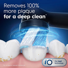 Toothbrush brush head with blue bristles helping remove plaque between teeth