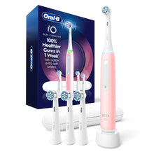 Pink Oral-B iO rechargeable toothbrush with charging base and 4 brush heads