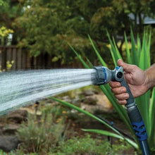 Telescoping spray wand with multi-pattern nozzle, held in a hand