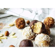 Chocolate truffles with coconut coating and exposed almond filling