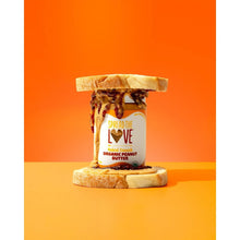 Crunchy organic peanut butter jar with lid and peanut butter spread on plate