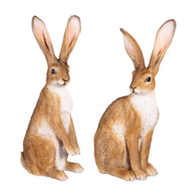 Two ornamental hare figurines, tan with white belly, sitting with long pink ears