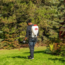 2-gallon backpack sprayer worn by a person, showing ORTHO tank and wand