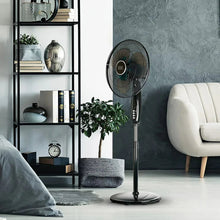 Oscillating pedestal fan with black grille and control handle, standing on round base