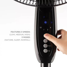 Black oscillating fan control panel with speed and mode buttons, hand pressing
