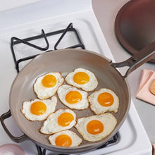 Nonstick skillet cooking pan with six sunny-side-up eggs