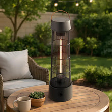 Electric patio heater lantern on a round outdoor table, glowing through metal mesh