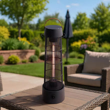 Black electric patio heater lantern with metal cage and arched handle on patio table