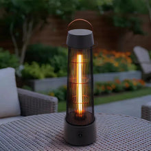 Black electric patio heater lantern on woven tabletop, warm glowing light inside