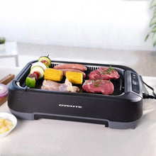 Smokeless griddle grill system with lid open, showing mixed meats and vegetables