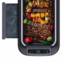 Smokeless griddle grill system with lid open, showing food on heated cooking surface