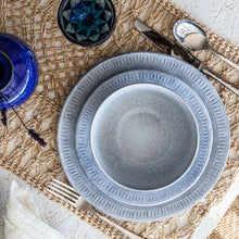 Ridged-rim blue-gray dinner plate with speckled glaze, top view