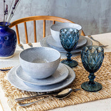 Blue-gray shallow bowl and ridged rim plate in a table setting