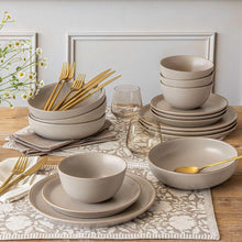 Taupe stoneware dinnerware set with stacked bowls and plates on a table setting