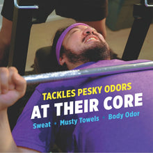 Laundry odor remover marketing image with purple cloth towel held in hand.