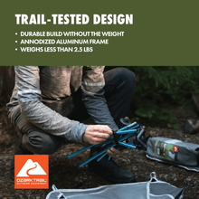 Ultralight backpacking chair with turquoise frame and gray mesh, with carry bag nearby