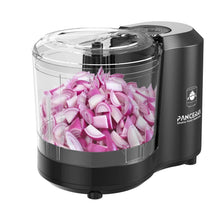 Black electric food chopper with clear bowl holding chopped purple onions
