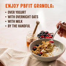 Protein granola with yogurt and berries in a bowl, with spoon and berries