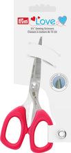 Crafting scissors with red plastic handles and stainless steel blades