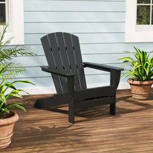 Dark gray adirondack chair with slatted back and wide armrests on a porch
