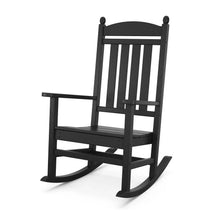 Dark rocking chair with slatted backrest, armrest supports, curved rockers