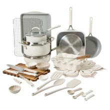 Beige ceramic nonstick cookware set with pots, lid, and matching utensils