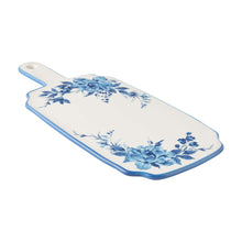 Blue stoneware serving board with white surface, blue floral wreath, oval handle