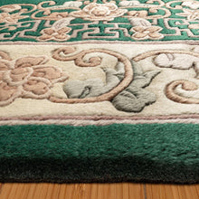 Close-up of green hand-knotted rug pile with beige floral and medallion pattern