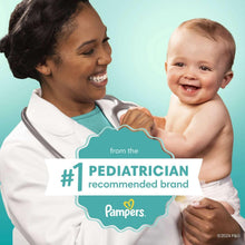 Baby wipes with caregiver holding a smiling baby and wipe pad