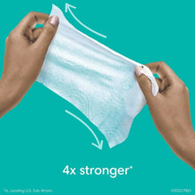 Hands pulling a baby wipe, 4x stronger label on package