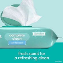 Teal Pampers Complete Clean wipes dispenser with baby fresh scent label and wipes pulled out.