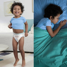 Child wearing light blue Bluey-print training pants with elastic leg cuffs