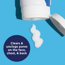 Acne wash tube dispensing a white creamy drop from an open cap
