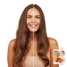 Two Pantene shampoo bottles beside a smiling woman with long brown hair