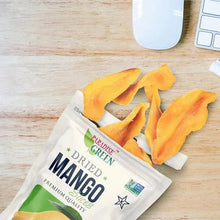Dried mango slices with opened pouch and loose fruit pieces
